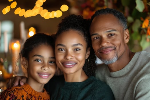 A family poses for a photo in front of a christmas tree