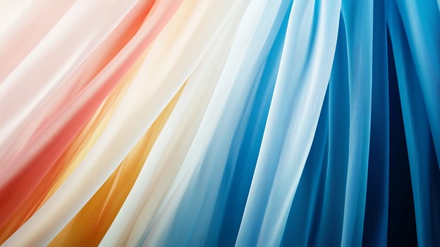 Colorful flowing fabric drapes in soft hues of orange, cream, blue, and teal, creating a serene backdrop photo