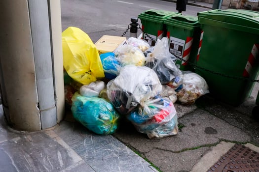 Transparent garbage bags dumped in the city street photo