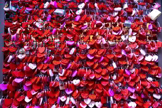 Red heart shaped padlocks on a wall Love photo