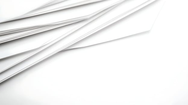 A collection of white sheets of paper arranged at an angle on a clean surface, ideal for backgrounds photo