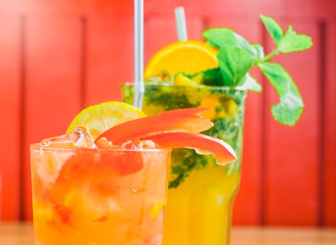 Colorful cocktails with fresh garnishes served at a vibrant setting during a summer gathering photo