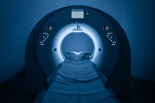 Medical CT or MRI Scan in the modern hospital laboratory. Interior of radiography department. Technologically advanced equipment in white room. Magnetic resonance diagnostics machine. Blue backdrop photo
