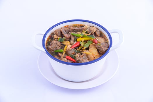 Thai favorite food. The spicy chicken soup in the white bowl. photo
