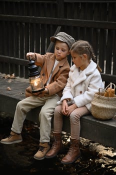 A boy and girl sit with lighter enjoy a simple meal on a weathered bridge, their wicker basket filled with fresh bread in a timeless, nostalgic moment. photo