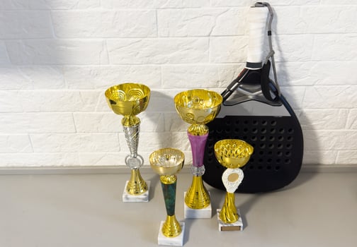 many sports awards and a tennis paddle racket photo