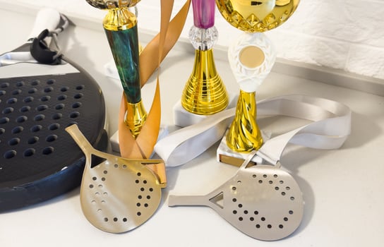 Golden trophy and padel racket. sport achievement, success concept. Business successful. photo