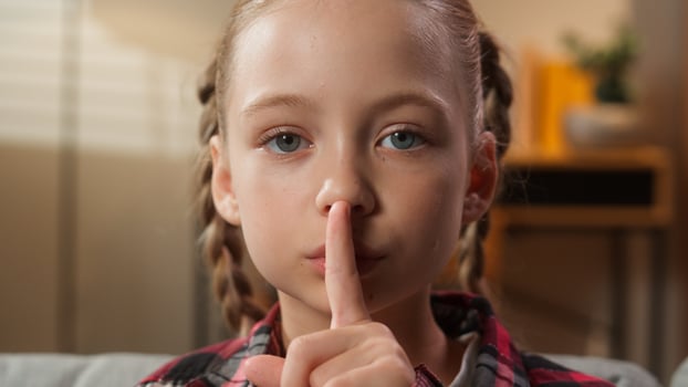Portrait at home serious calm Caucasian little girl female daughter adopt custody child kid teenager showing hush gesture silence sign holding index finger near lips silent secret family quiet secrecy photo