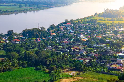 An aerial view of the skyline with village next to the river. photo