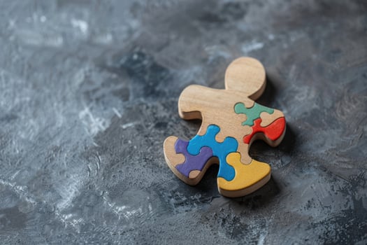 colorful painted pieces of wooden puzzle in the form of a man human person, photo