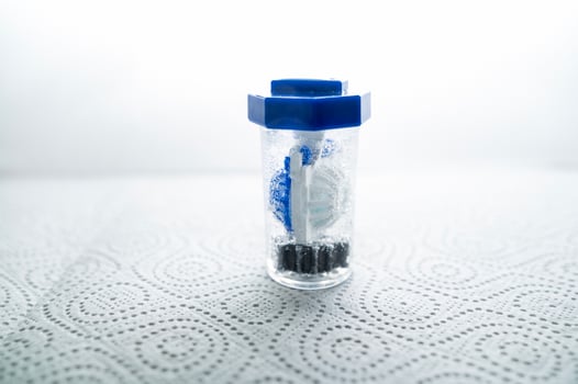 close-up of a container for cleaning and storing contact lenses for the eyes, used at home. For soft and hard lenses. in the container there is an active cleaning process, bubbles are released photo
