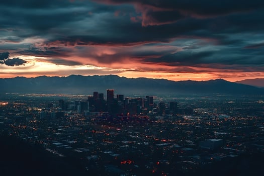 Salt lake city skyline emerging from darkness at sunset with dramatic cloudscape photo