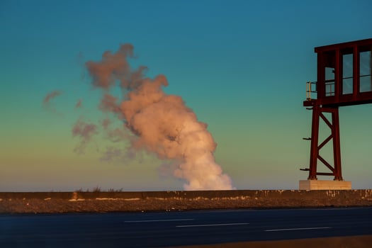 Thermal power stations and power lines during sunset Power plant with smoke and dirty orange air photo
