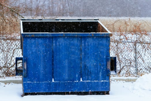 Trash bin at the side of street in winter with lip garbage container winter snow photo