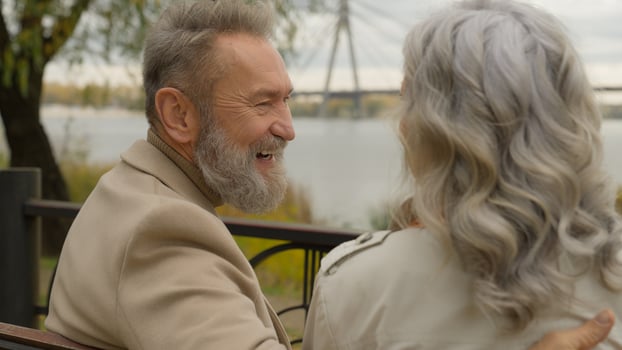 Happy family senior retired Caucasian 60s man laugh smile talk with woman romantic date weekend in city park cheerful joyful old male female laughing enjoy relaxing affectionate love couple outdoors photo