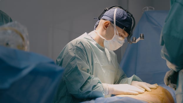 Doctor man in uniform physician surgeon medic nurse performing surgical operation at hospital clinic plastic surgery microsurgery saving life patient health emergency medical help medicine healthcare photo