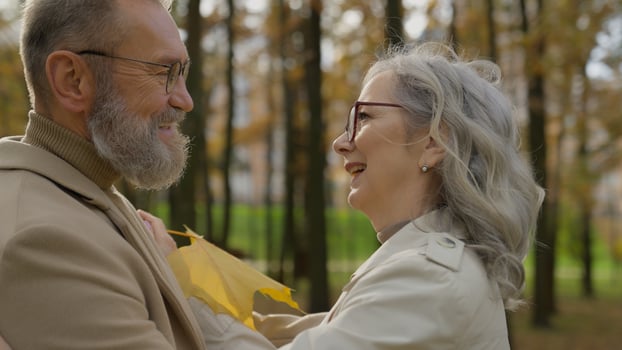 Married couple cheerful happy old age Caucasian family smiling mature senior 60s age woman man enjoying romantic outdoors tender love feelings closeness bonding adults male female talking in city park photo