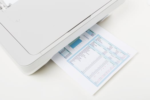 Printer working on a document with financial data in a home office on a bright afternoon photo