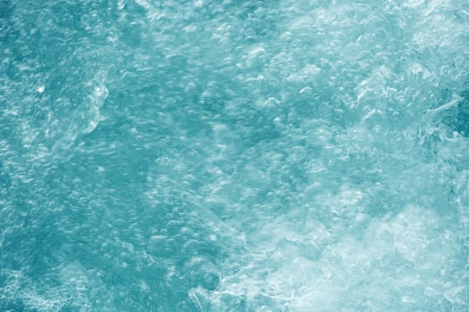 Abstract transparent water texture, bubbling clear water as textured background, purity and beauty of nature, natural ripples and waves on turquoise aquatic surface, nature environment photo