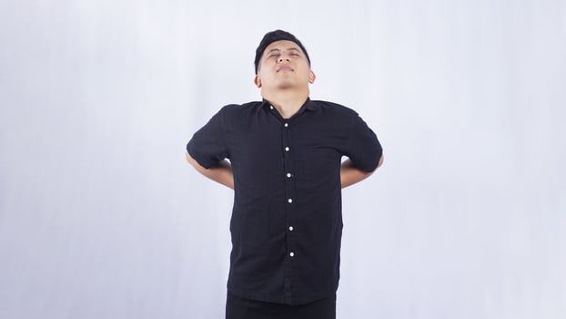 Asian Young Man with Back Pain on White Background photo