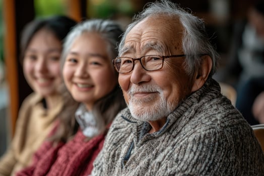 Portrait of smiling senior man with his family members in background photo