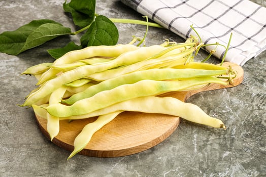 A bunch of beans on a wooden cutting board photo