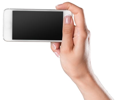 Hand holding a smartphone ready for taking a picture in bright lighting conditions indoors photo