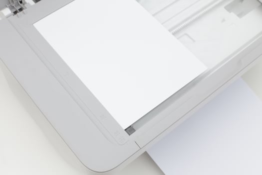 Scanner showing blank paper ready for scanning documents in a well-lit home office environment photo