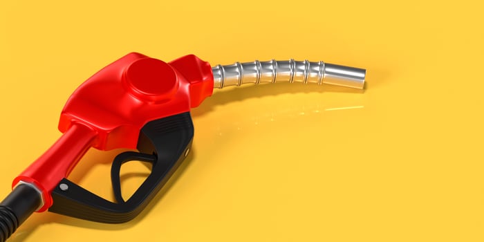 Red fuel nozzle on yellow background photo
