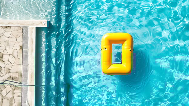 Swimming pool with yellow inflatable ring in swimming pool, top view photo