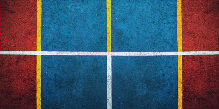 Colorful court lines create a vibrant pattern on a sports surface during daylight hours photo