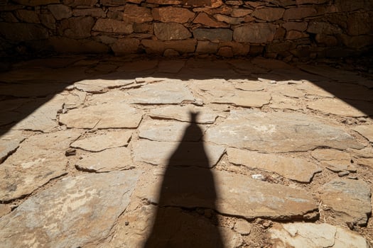 Shadow of a person on a stone floor in a building photo