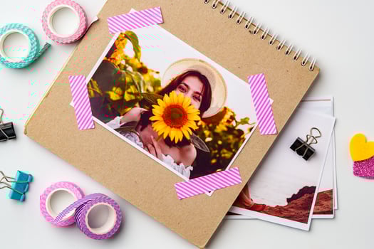 Creative scrapbook page featuring a young woman holding a sunflower against a colorful background with decorative elements photo