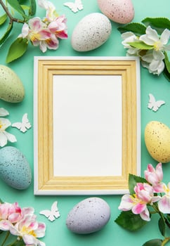 Easter eggs and flowers bordering a blank frame photo