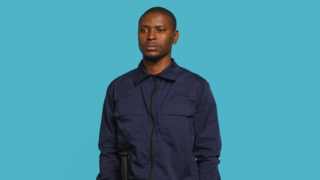 Security guard tasked with preventing criminal activity and detaining suspects stealing, damaging property, or performing other crimes. Portrait of intimidating bodyguard, studio background, camera A photo