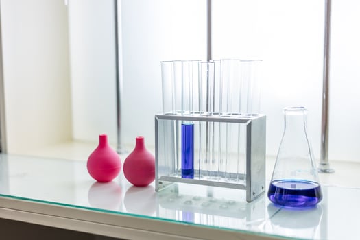 A glass table with a glass vase and a test tube photo