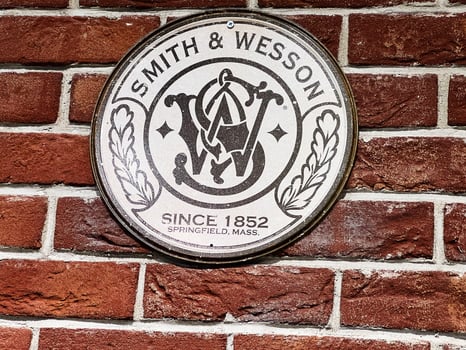 Lviv, Ukraine - February 13, 2025- Smith and Wesson emblem displayed on a red brick wall background photo