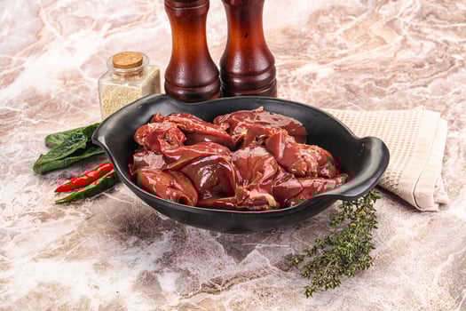 A bowl of meat and spices on a marble counter photo