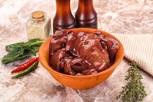 A bowl of meat and spices on a marble counter photo