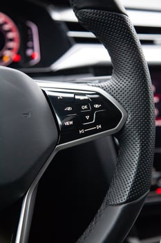 Buttons on the modern multifunctional steering wheel for controlling music and multimedia photo