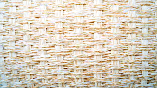 Close-up of a woven texture showcasing intricate patterns and natural fibers in a neutral tone photo