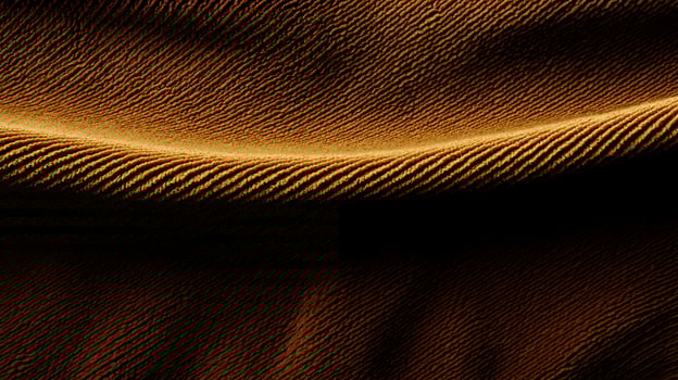 Close-up of flowing golden fabric showcasing elegant texture and soft shadows photo
