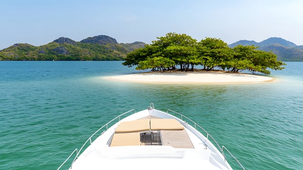 Scenic view from a boat towards a serene island with lush greenery and calm waters photo