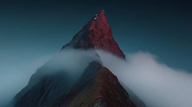 Majestic mountain peak shrouded in mist at twilight, showcasing natural beauty and serenity photo