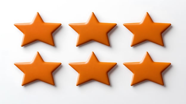 Six vibrant orange star-shaped objects arranged symmetrically on a white background photo