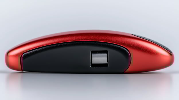 Sleek red wireless mouse on a smooth surface, showcasing modern design and technology photo