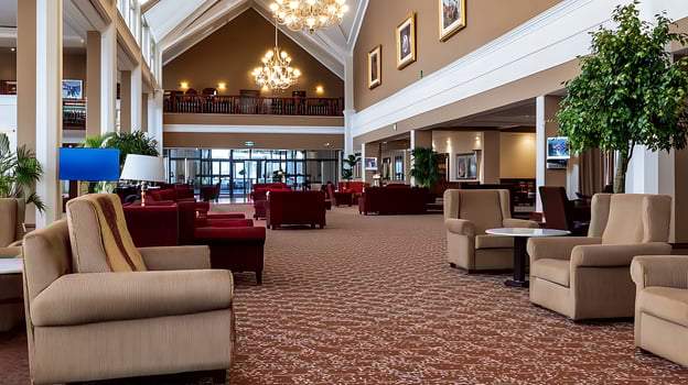 Spacious hotel lobby with elegant decor, cozy seating areas, and large windows letting in light photo