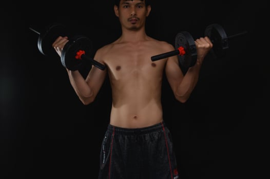 Determined Man Lifting Dumbbells for Strength and Health Improvement photo