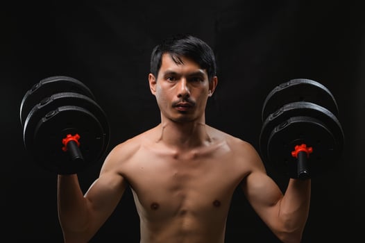 Strong Man Lifting Dumbbells for Fitness and Health Training photo