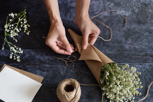 Medium height woman working with dried flowers assemble composition, decor and floristry concept photo